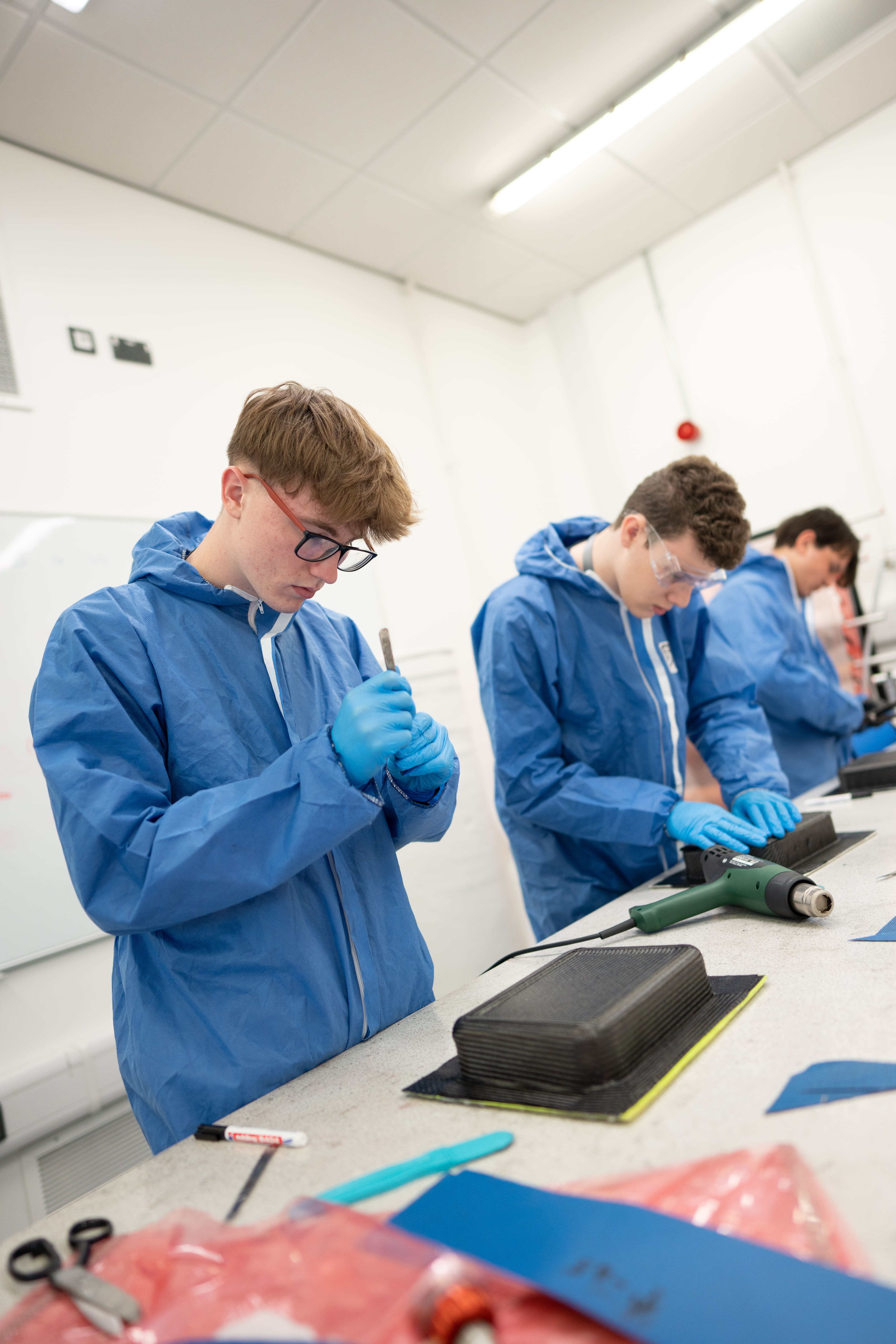 students in body suits moulding plastic