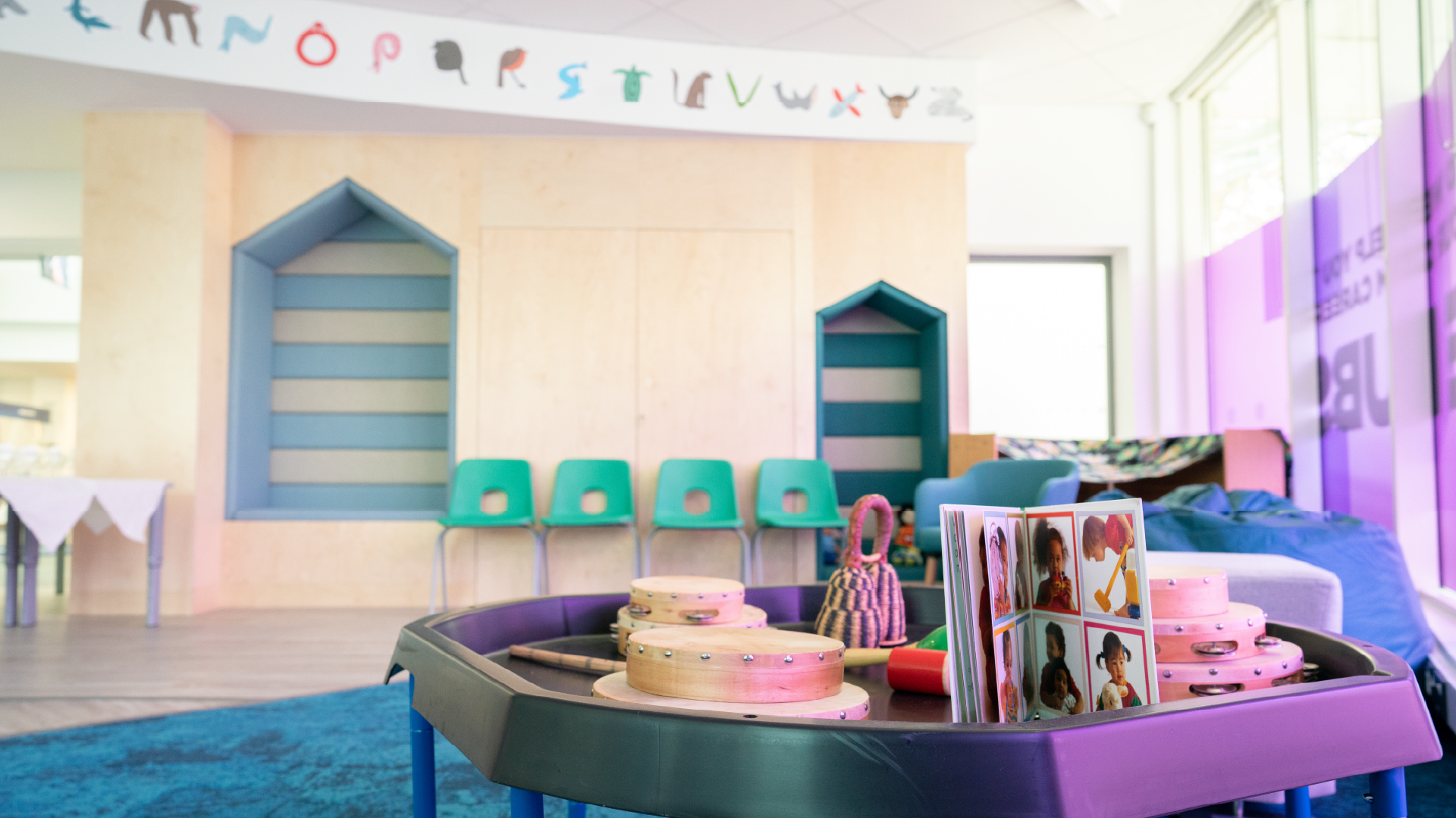 a early years classroom with tables and chairs with close up on children's play table
