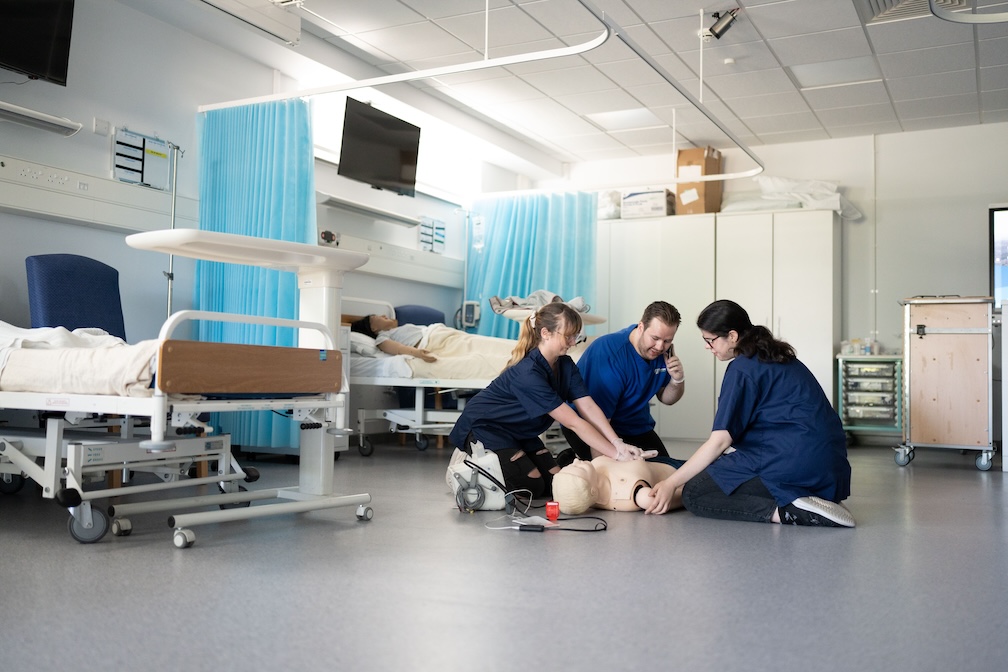 students working on a CPR doll