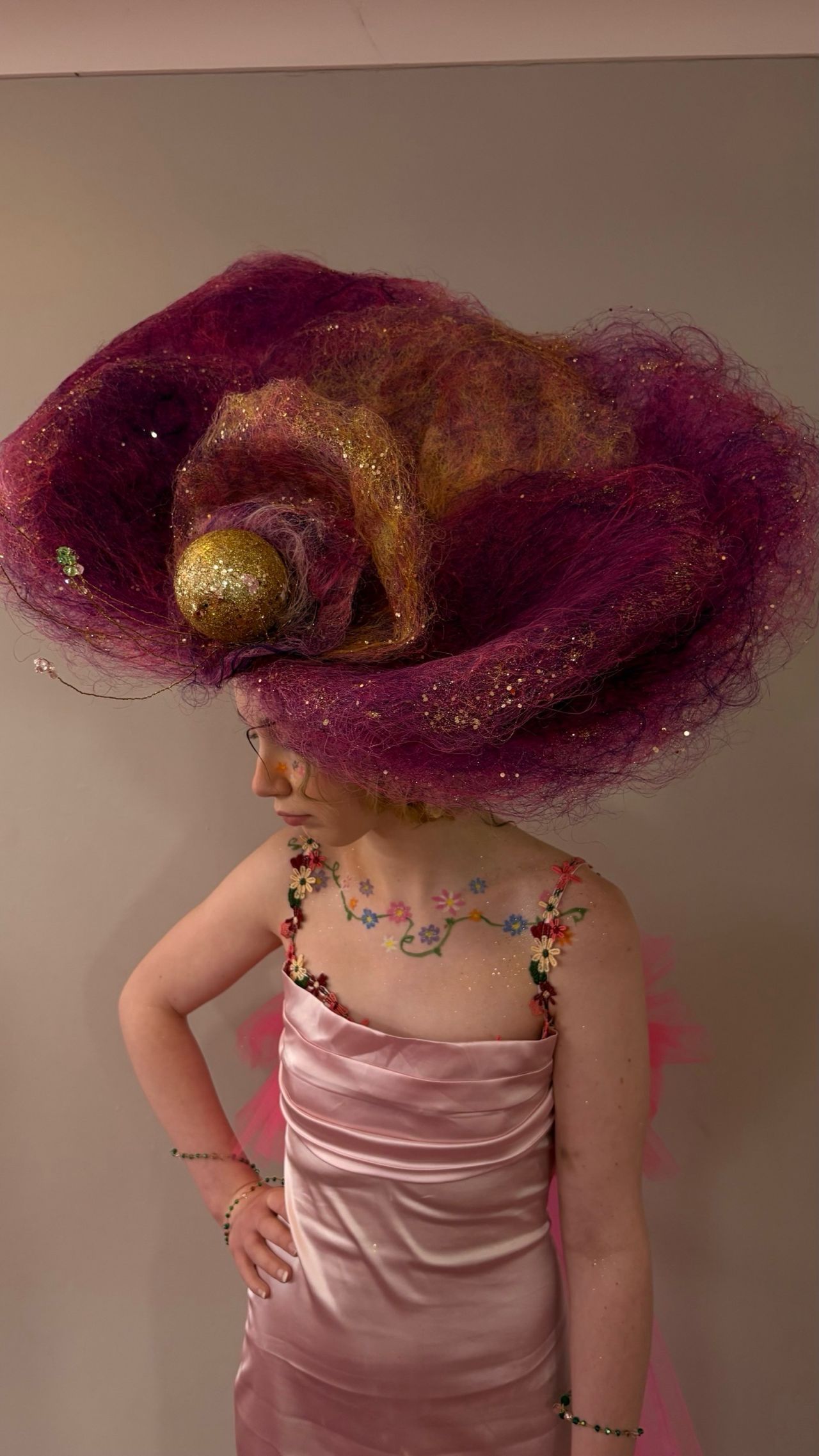 Student with a large felt pink headdress