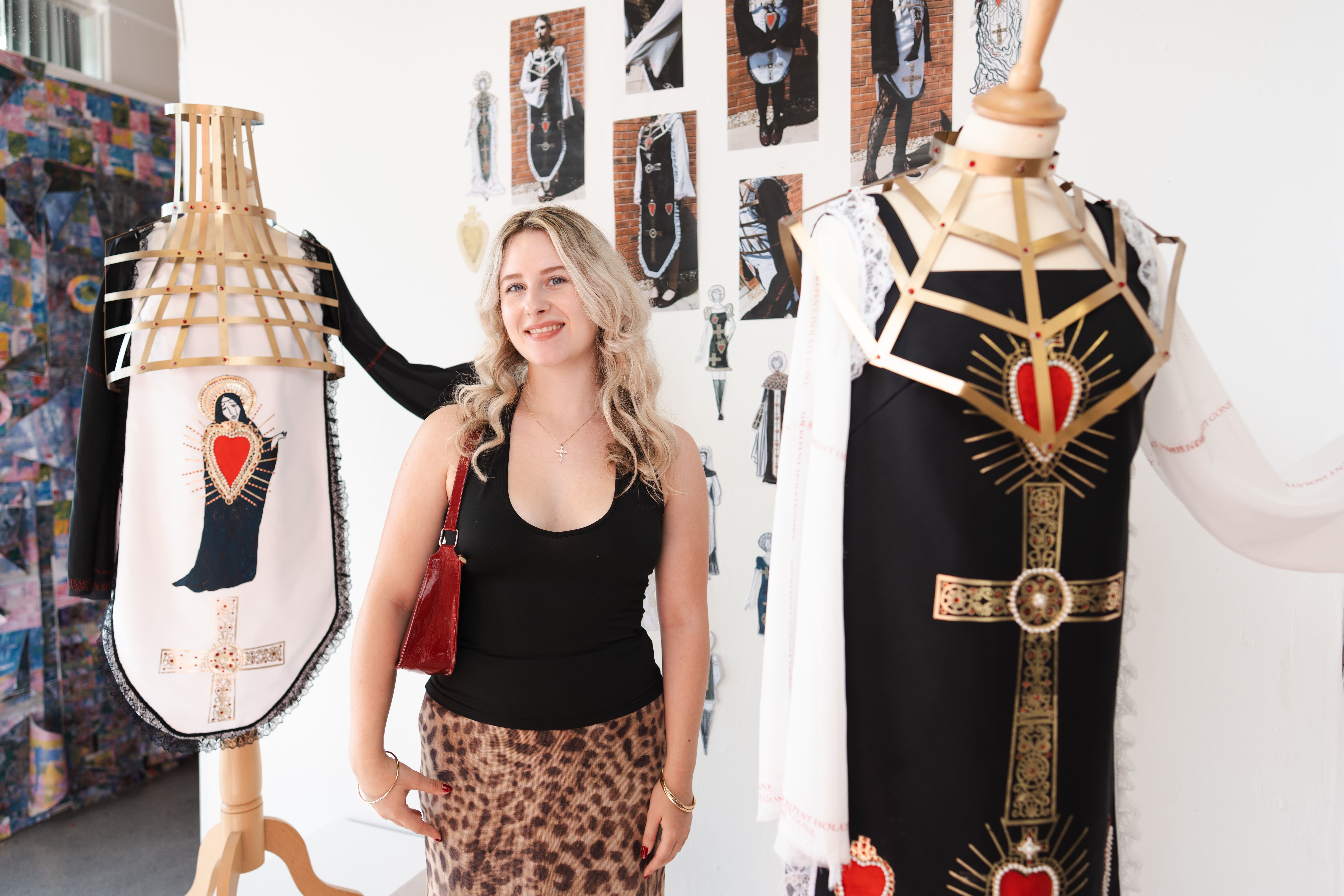 Girl standing next to her dress design