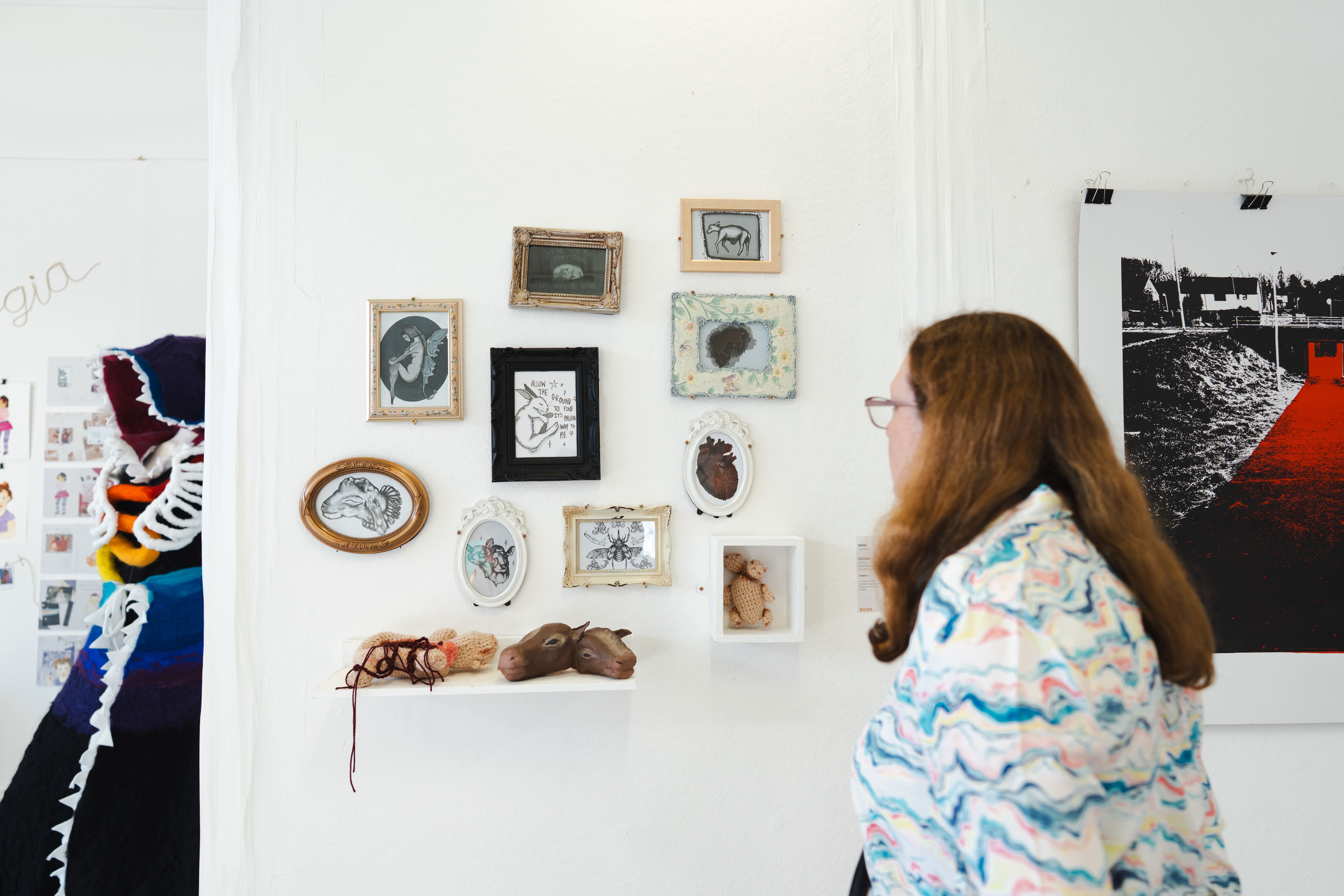 a women looking at paintings on a wall