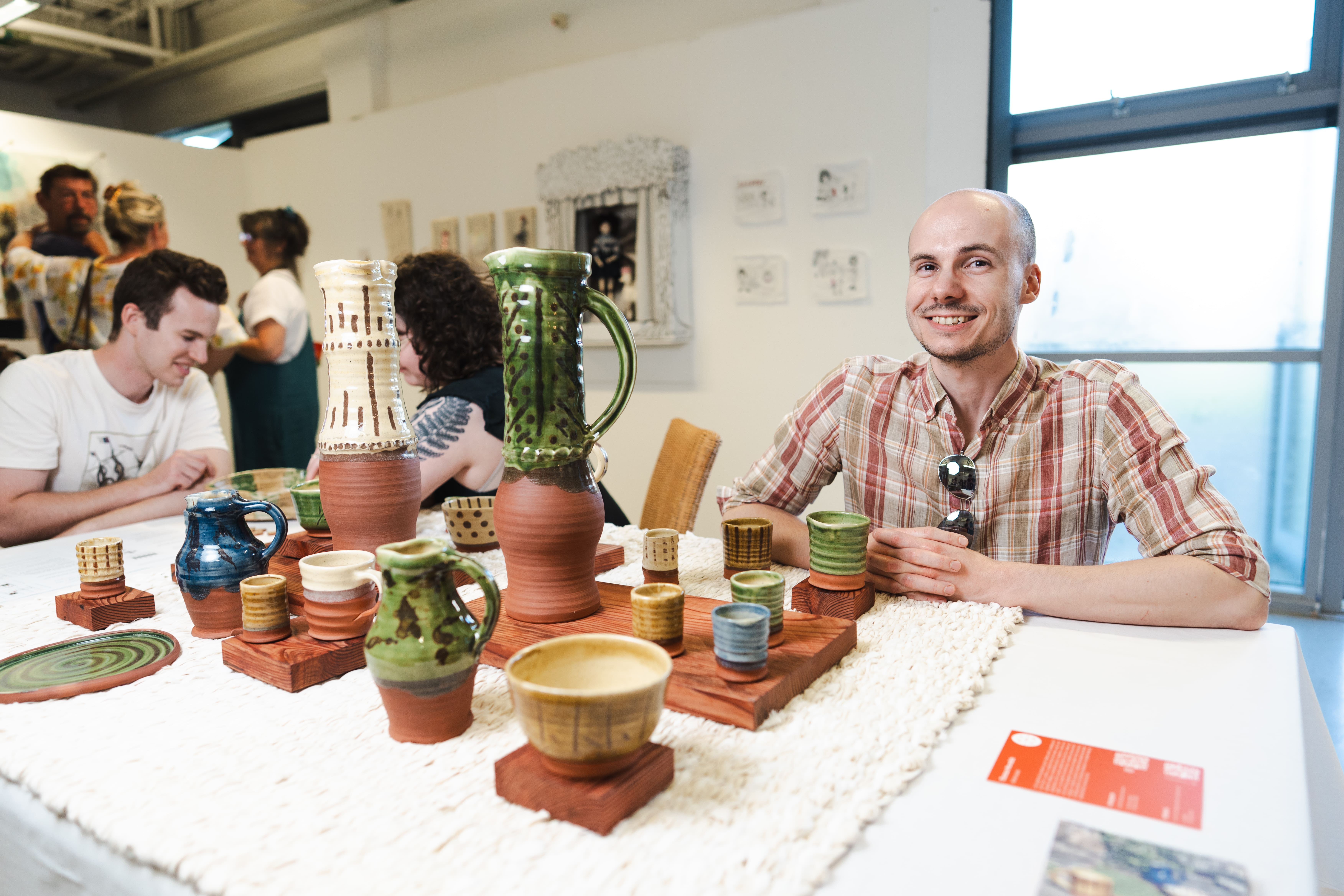 a man poses next to his art poetry