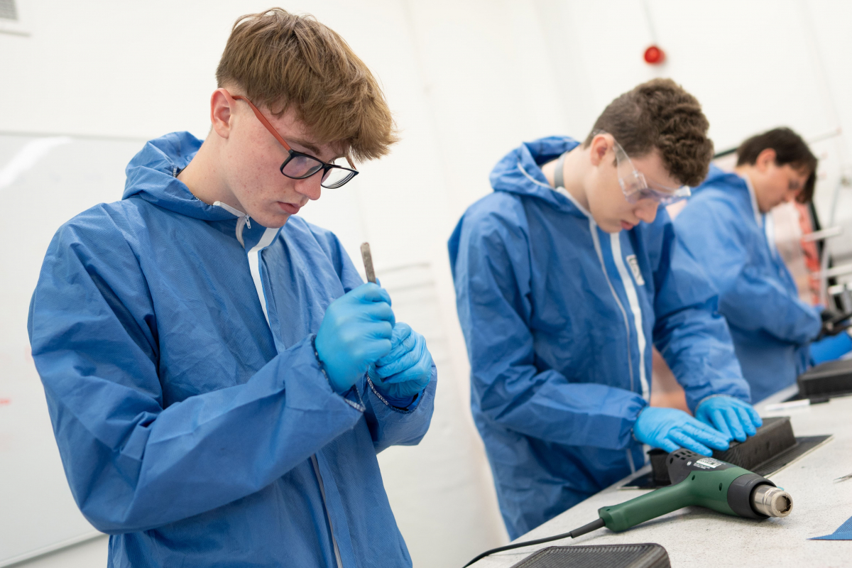 students in body suits moulding plastic