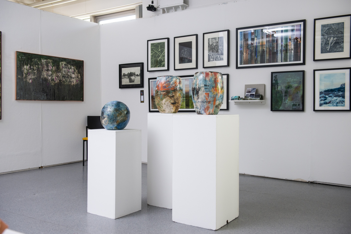 a room filled with art and pictures on the wall 