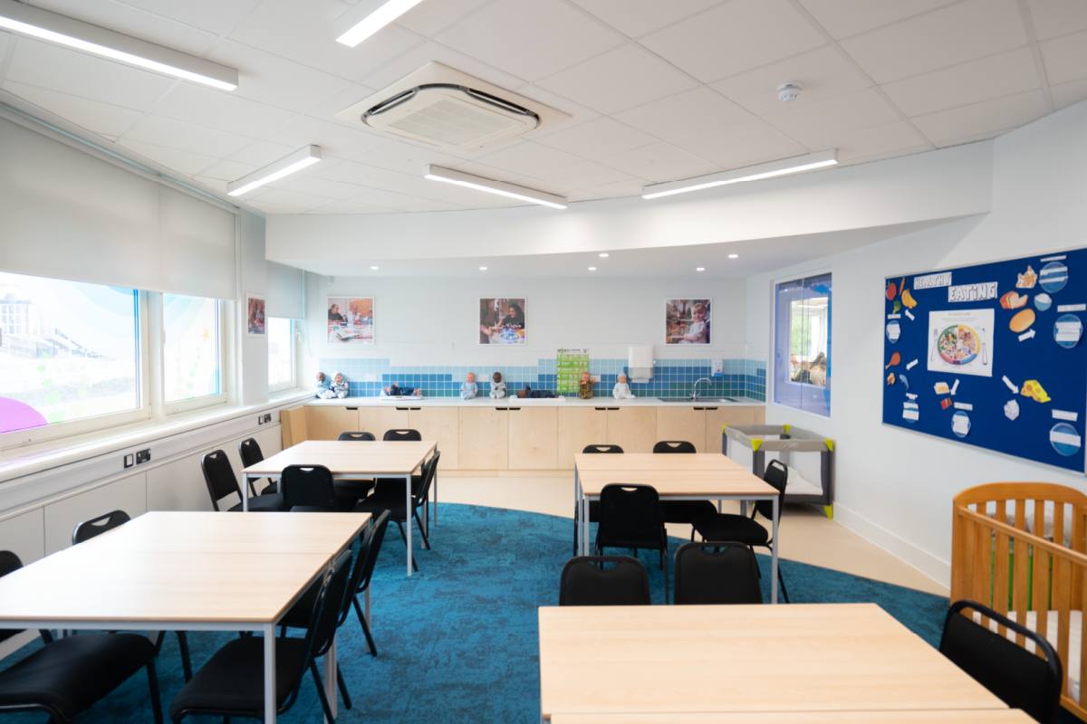 a early years classroom with tables and chairs