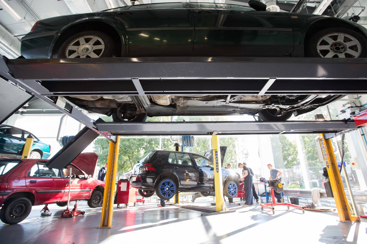 2 cars on ramps in motoring facilities