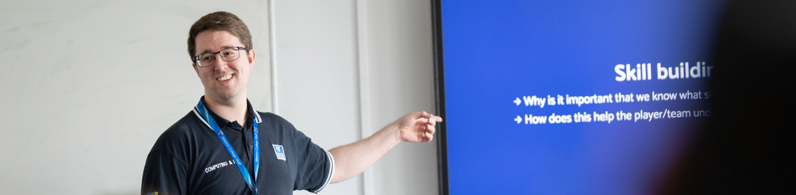 Lecturer pointing at the board