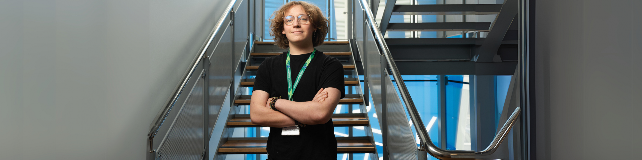 engineering student standing in front of staircase