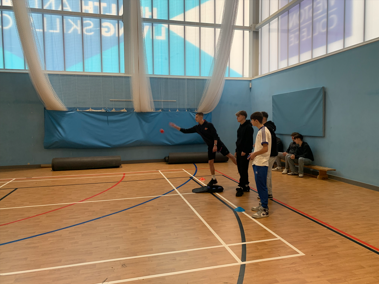 Sport coaching learners demonstrating boccia to the young learners
