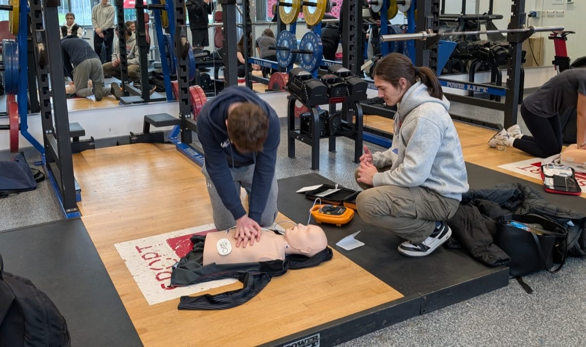 Student practicing CPR on a dummy