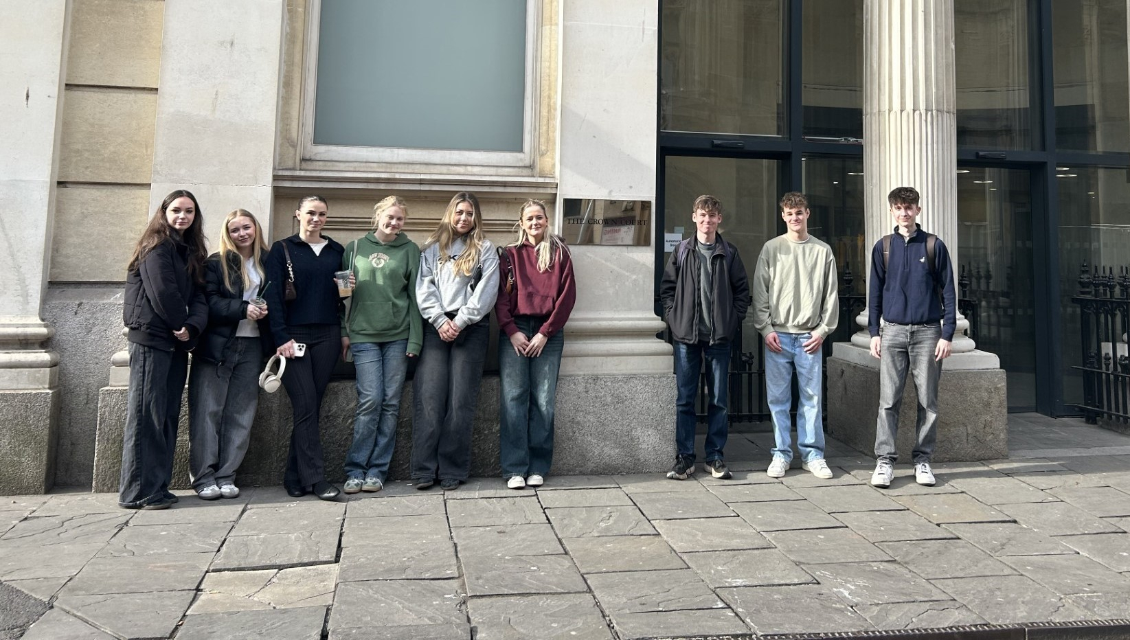 Group of 9 Law students standing outside Bristol Crown Court smiling
