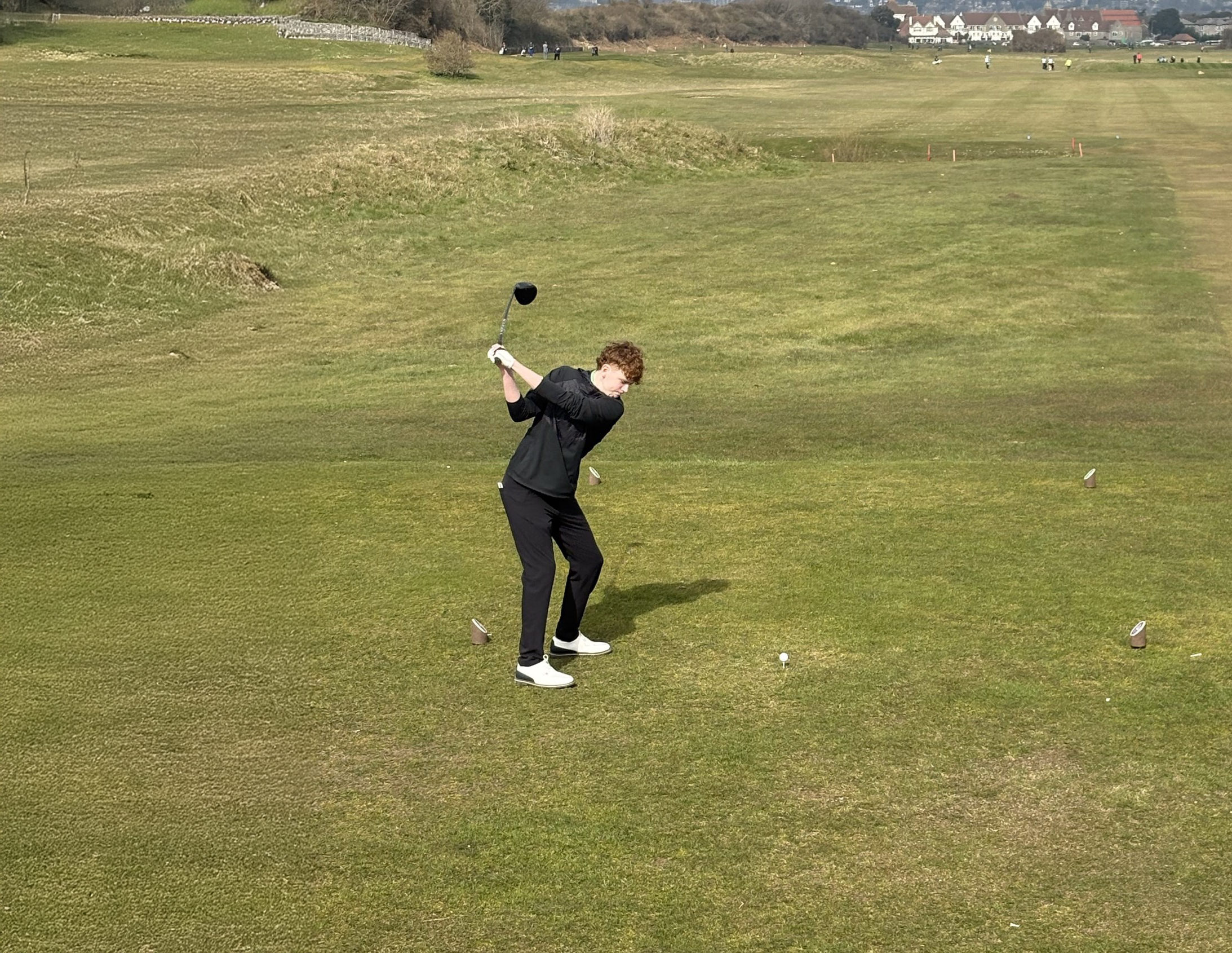 Troy taking a swing on the golf course