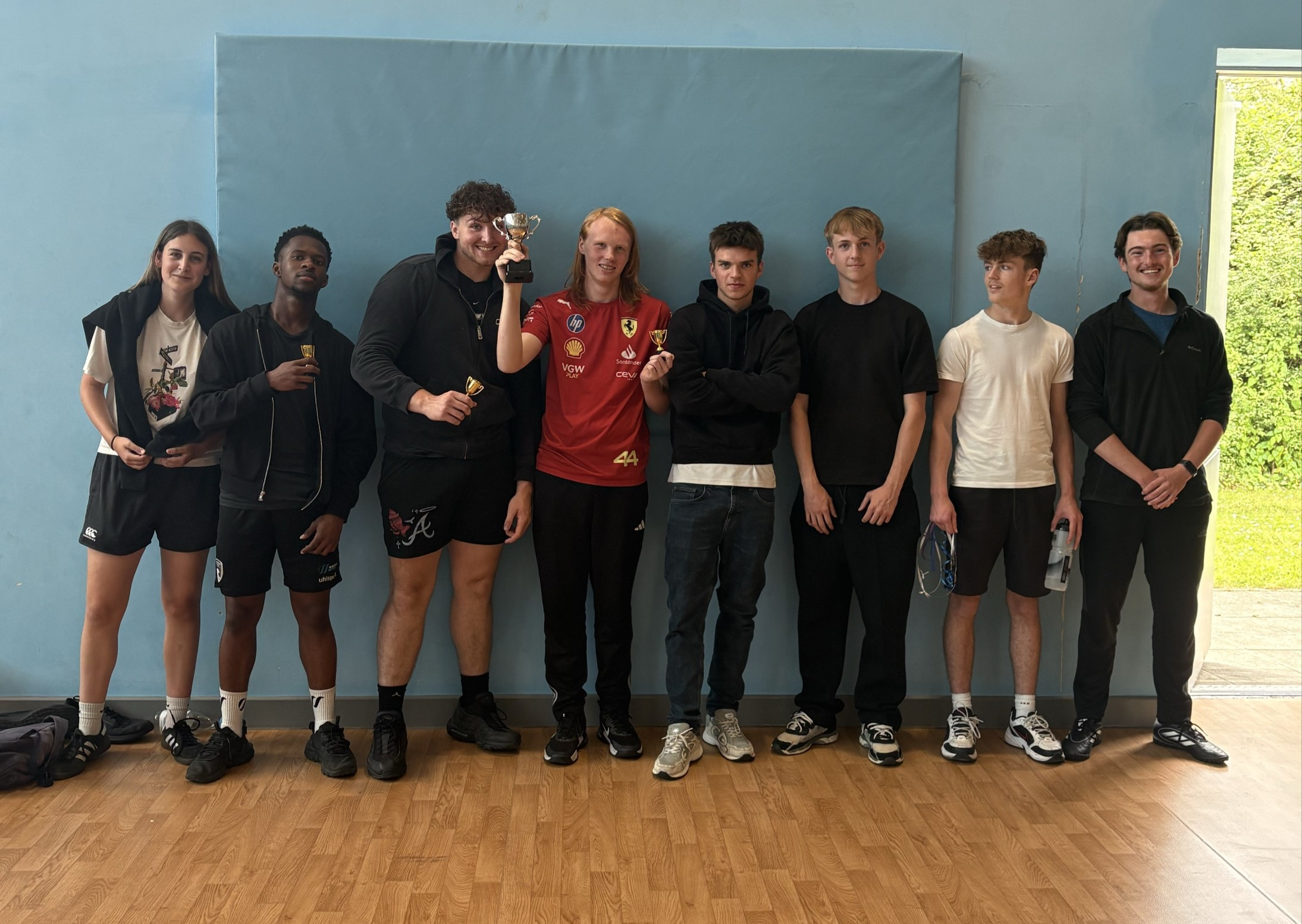 Winning group of sport students holding a trophy