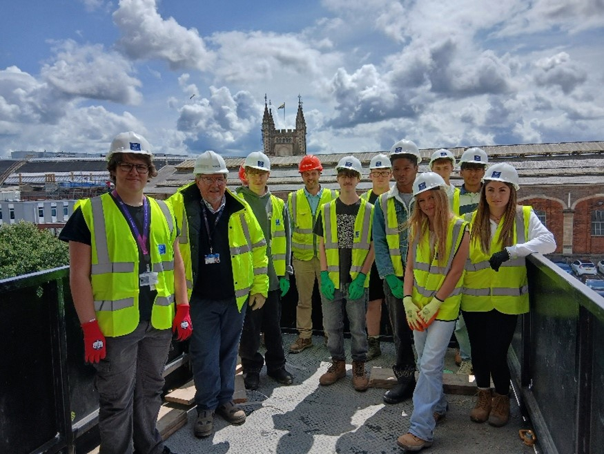 Students wearing HI-Vis jackets in the Welcome Building construction site