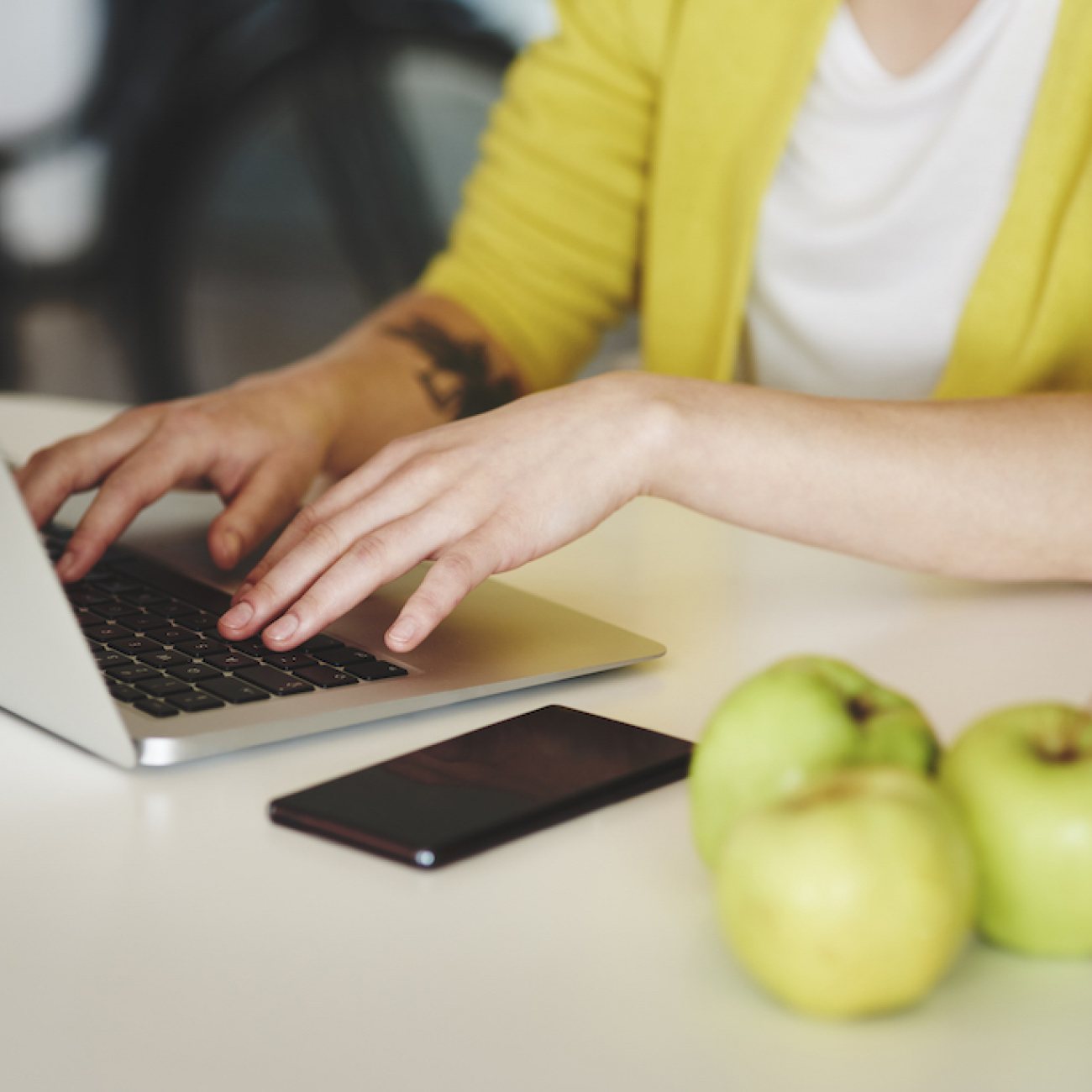 Lady typing on a laptop