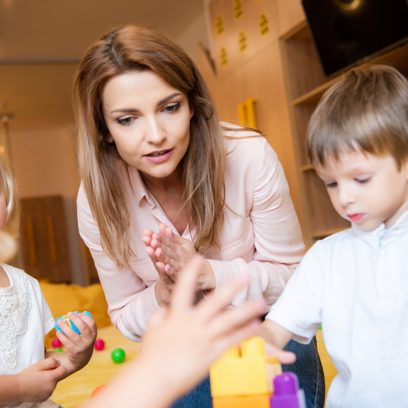 Early Years Educator with children as they play and learn