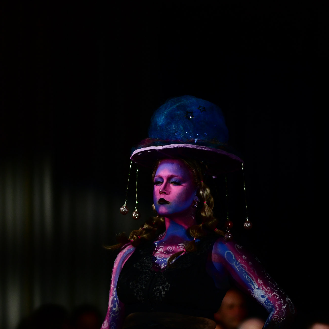Student modelling a jellyfish-style design with galaxy-themed body paint