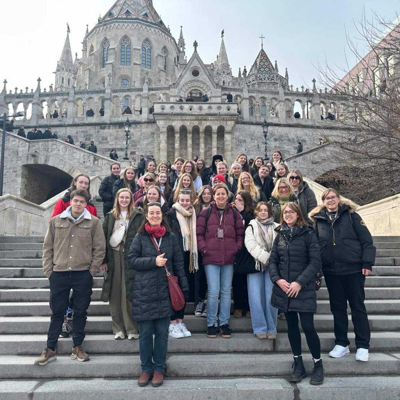 Early Years students standing on steps in front of a big building in Budapest