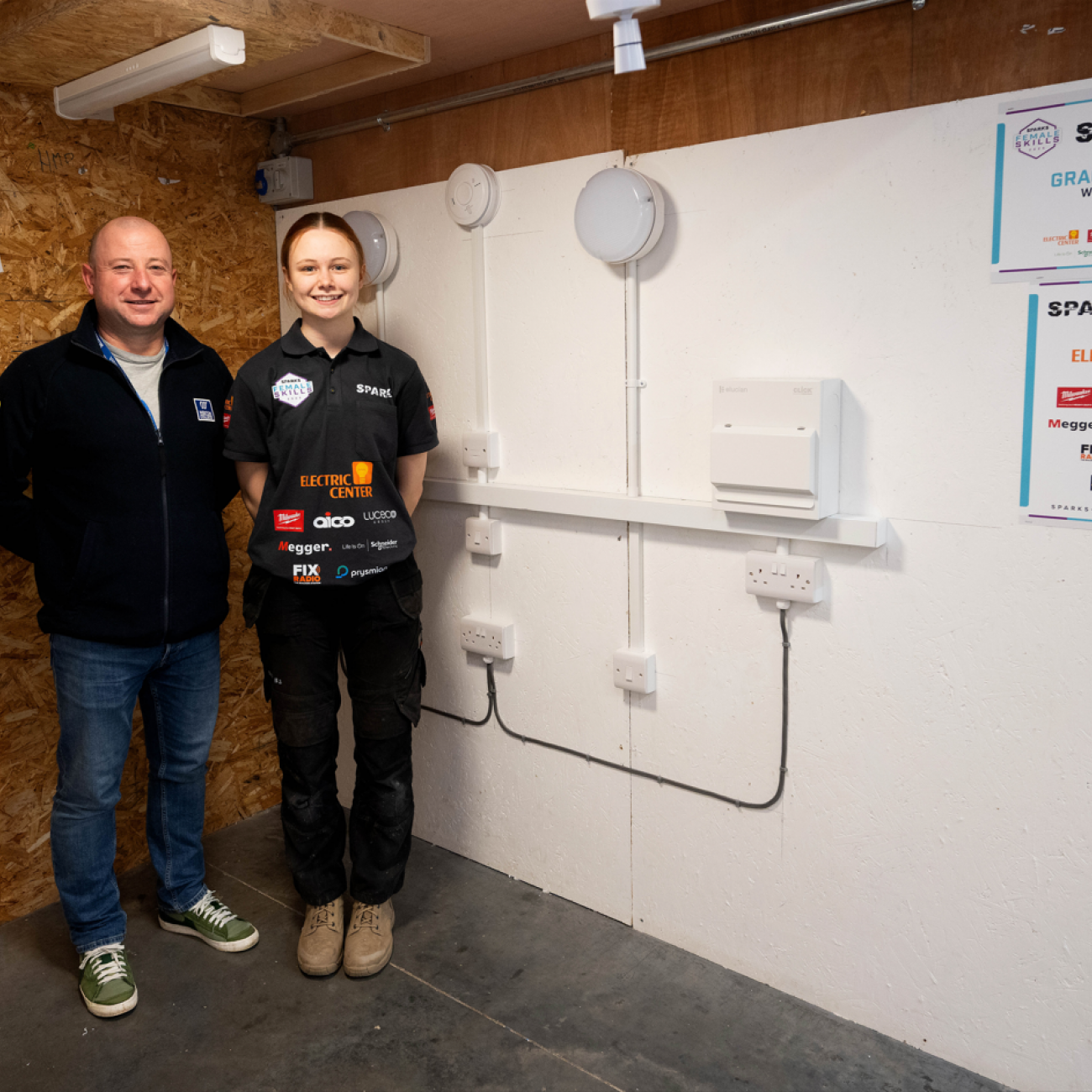 Gracie and her lecturer, Andy, standing next to her final installation
