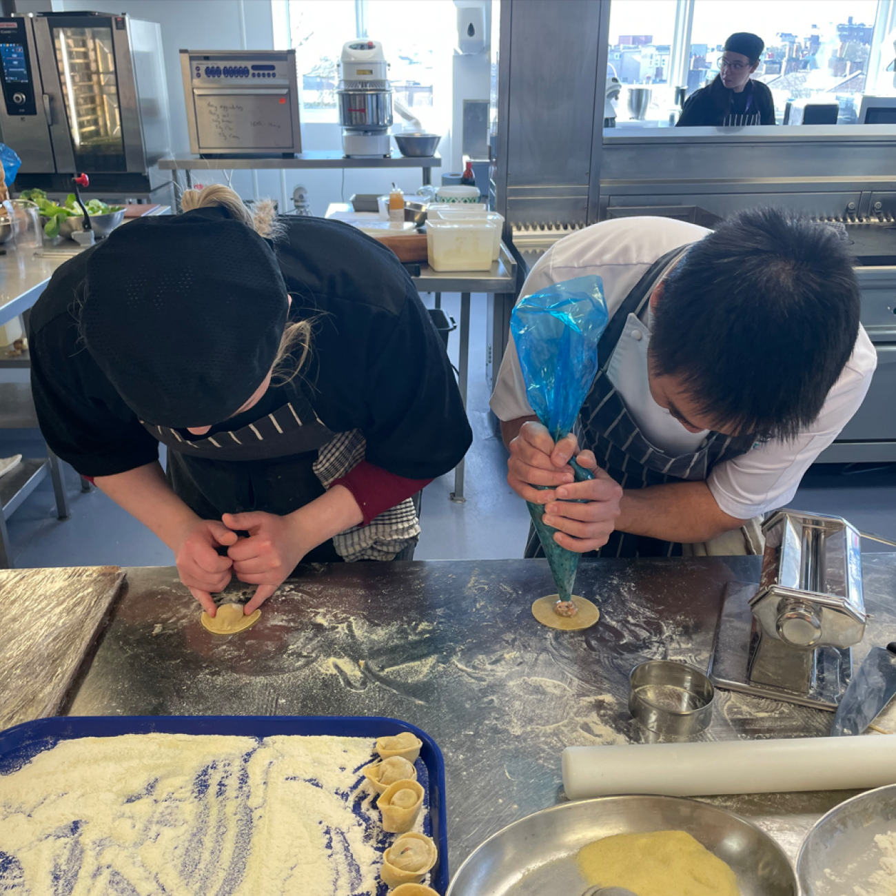 Andy and a student making dumplings