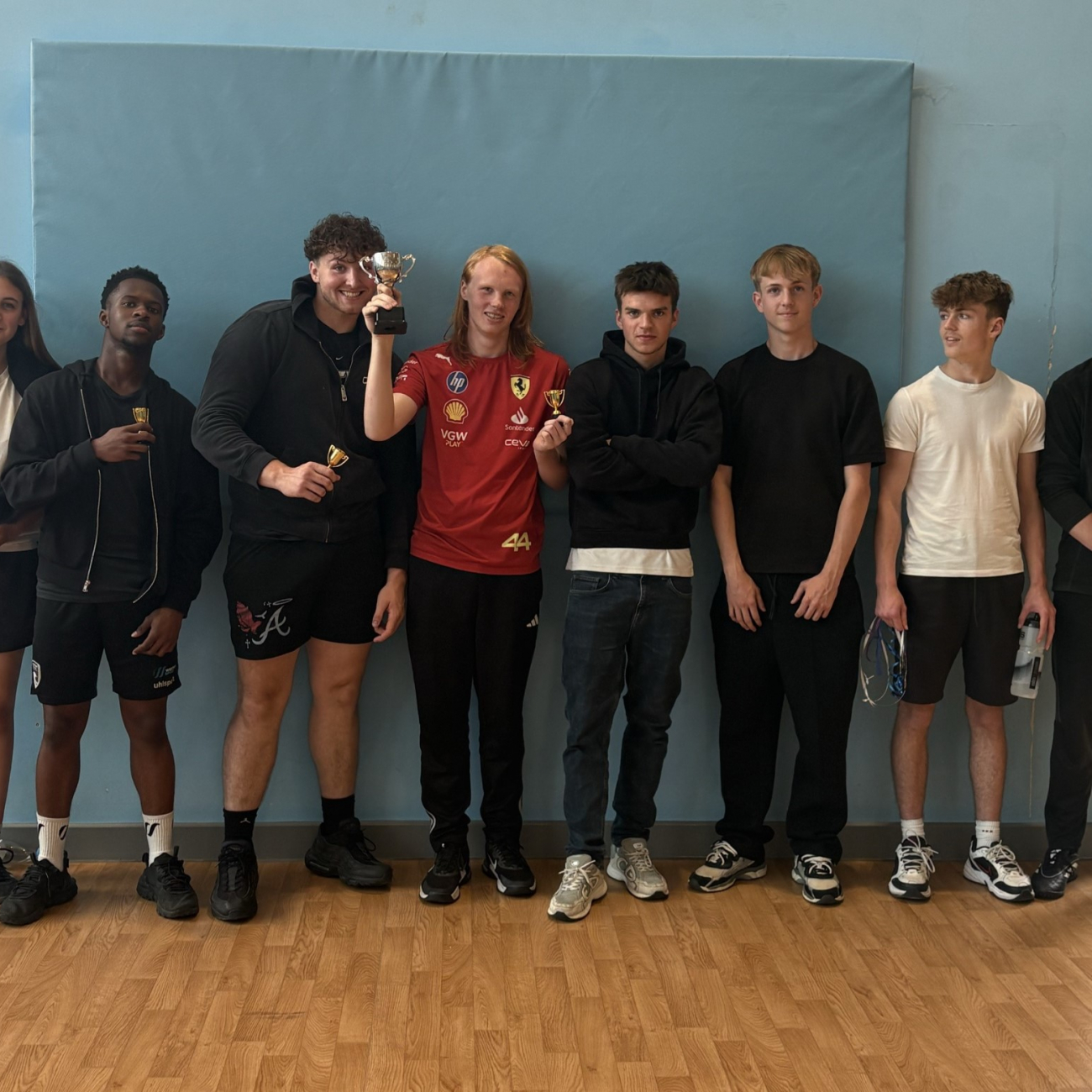 Winning group of sport students holding a trophy