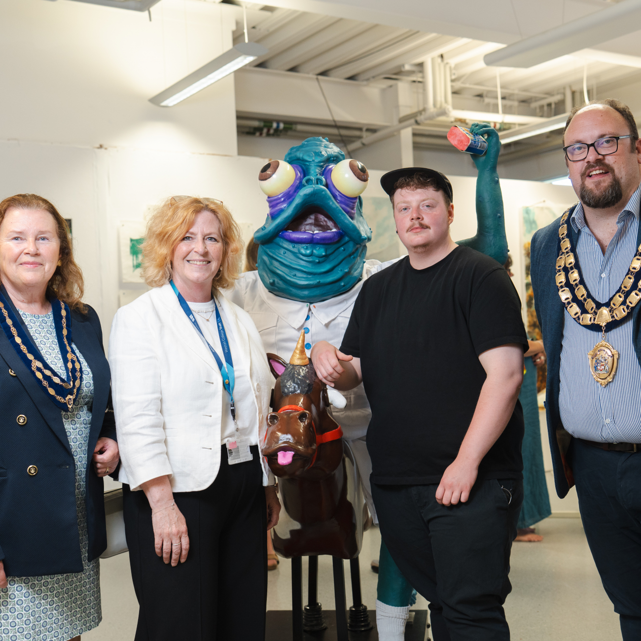 Principal and CEO of Weston College, Pat Jones, and Weston-super-Mare Mayor standing with a student and his work