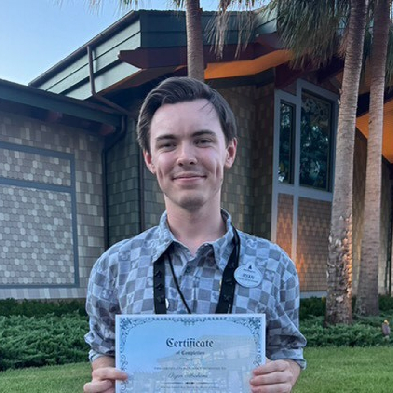 Ryan holding up a certificate whilst smiling