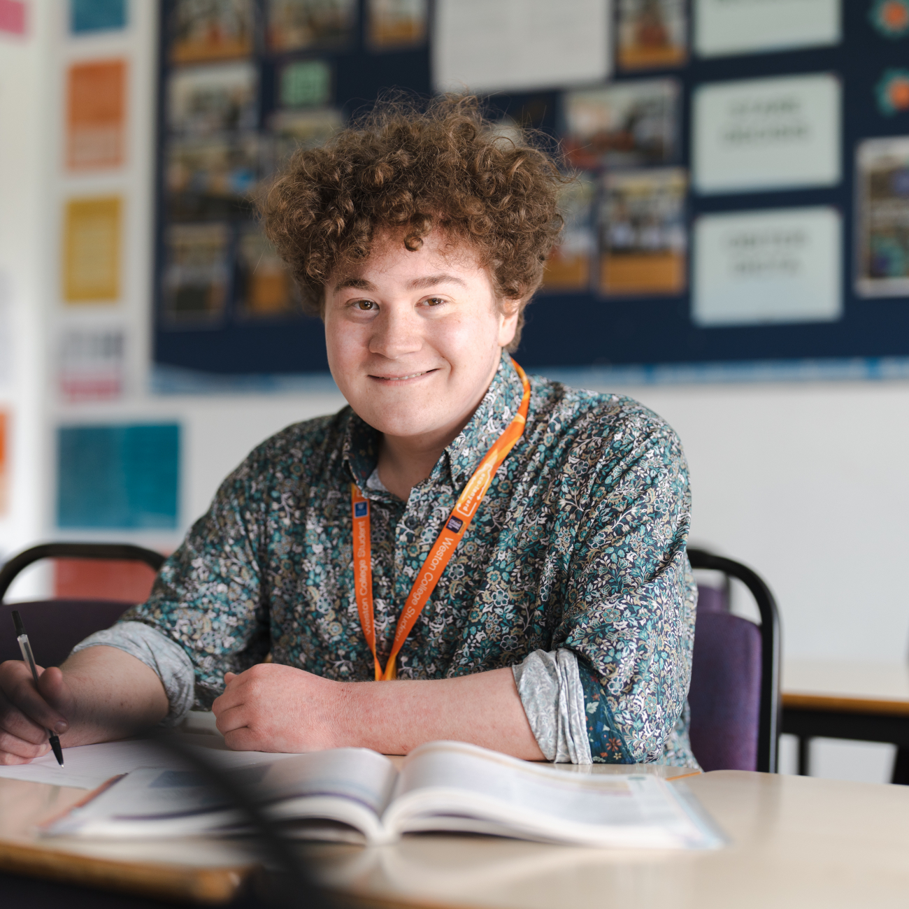 A Level student writing in a workbook