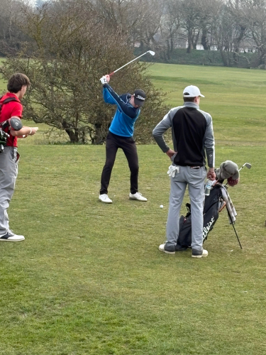 Students getting ready for their turn on the golf course