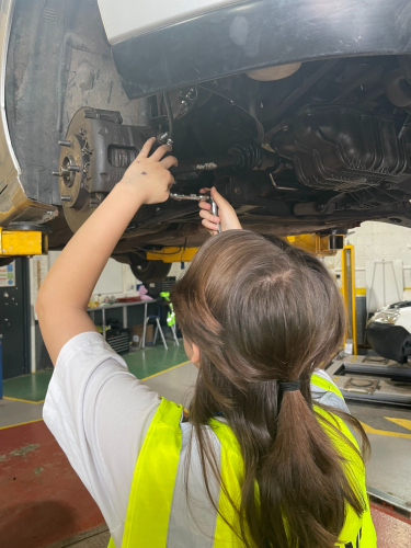 Student assembling part of the car wheel mechanism