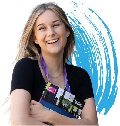 girl holds book and smiles at camera